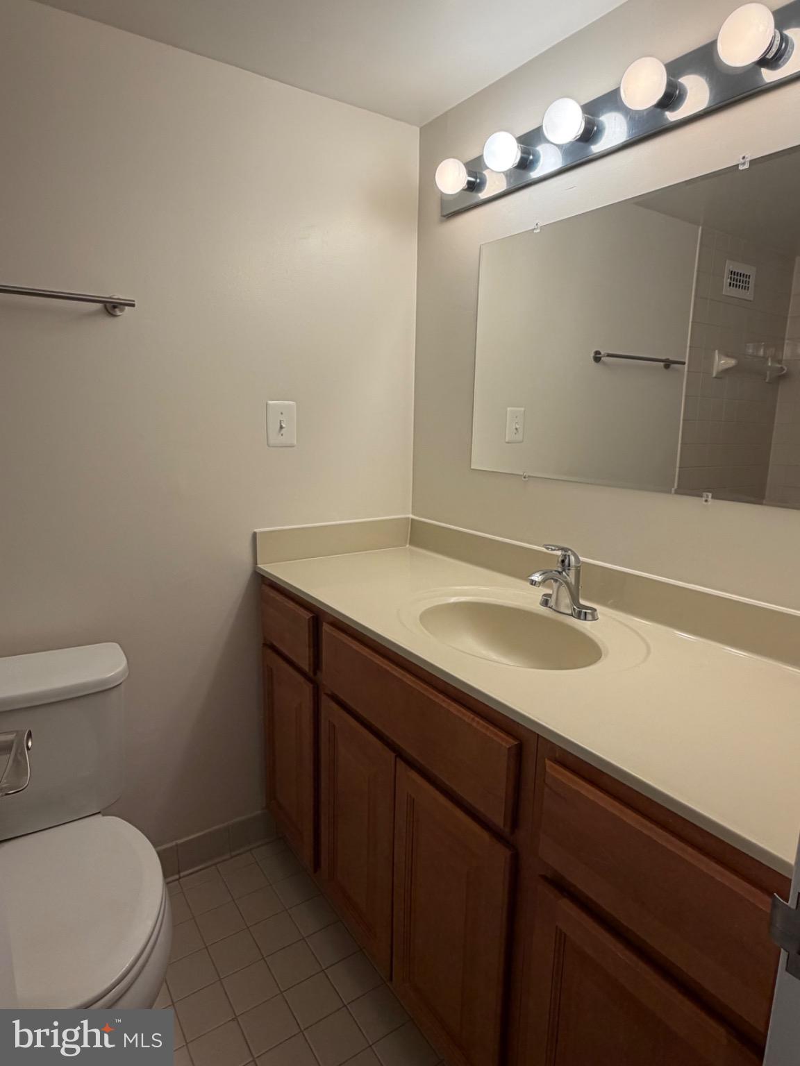 5225 Pooks Hill Road, Unit 1804N Bethesda, MD 20814 - Photo 11 of 44 a bathroom with a sink a toilet and a mirror
