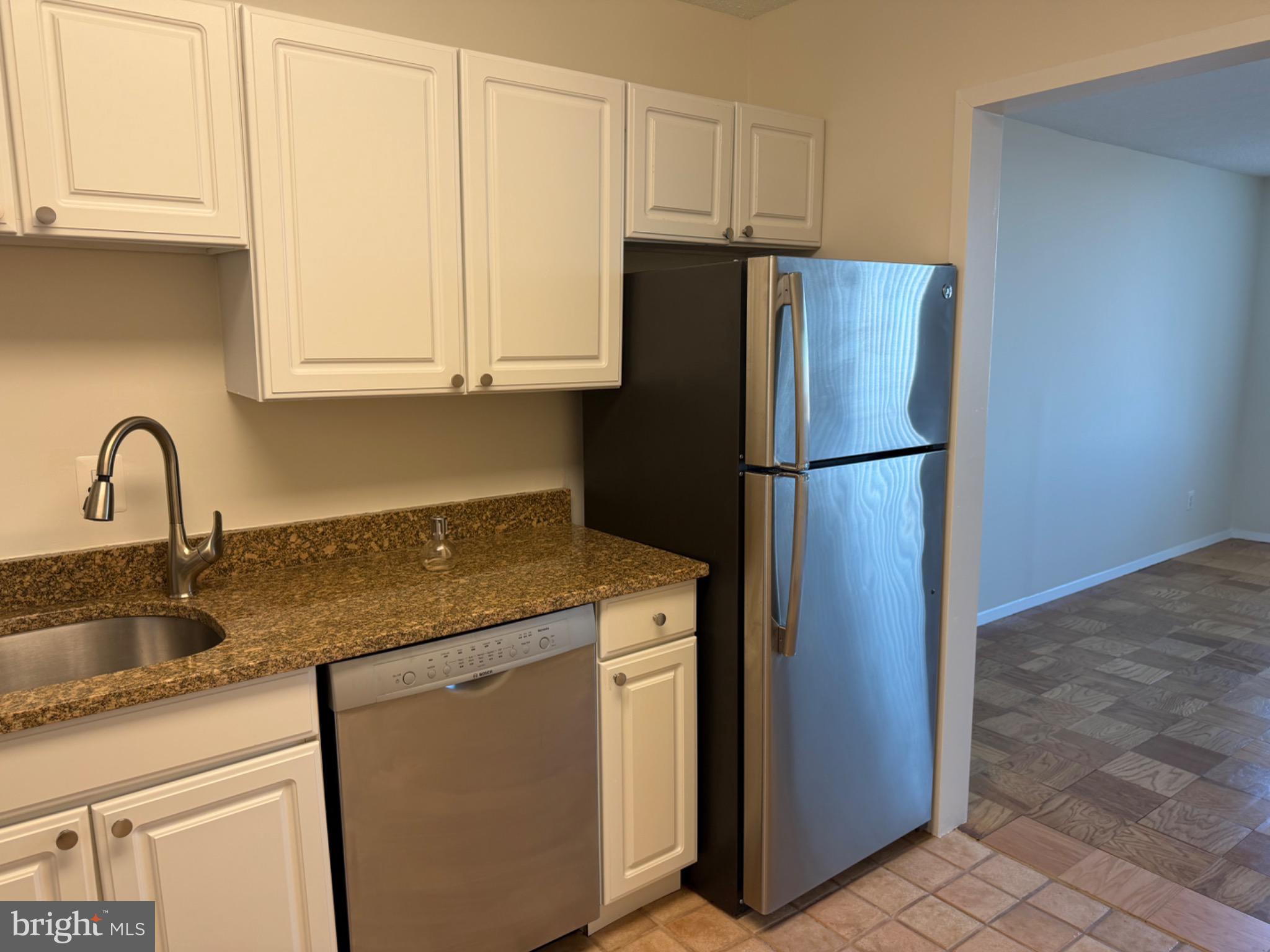 5225 Pooks Hill Road, Unit 1804N Bethesda, MD 20814 - Photo 8 of 44 a kitchen with a refrigerator sink and cabinets