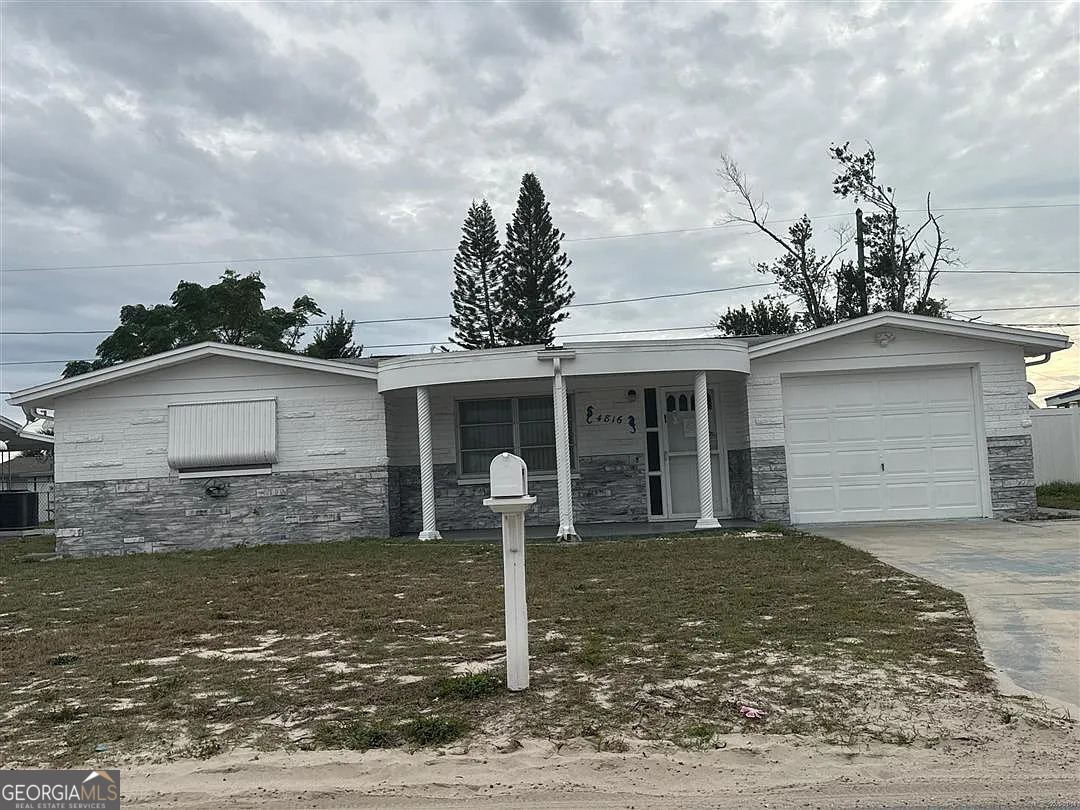 4816 Panorama Avenue Holiday, FL 34690 - Photo 2 of 5 a front view of a house with garden