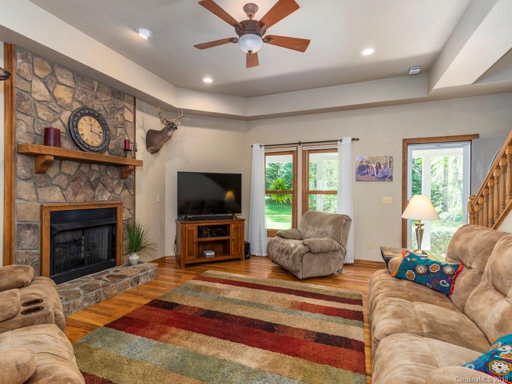 58 Thunder Ridge Road Canton, NC 28716 - Photo 2 of 26 a living room with furniture flat screen tv and a fireplace