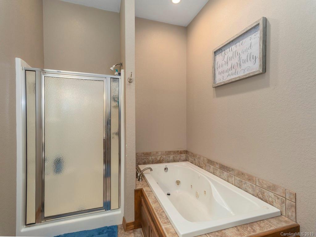 58 Thunder Ridge Road Canton, NC 28716 - Photo 11 of 26 a bathroom with a white bath tub