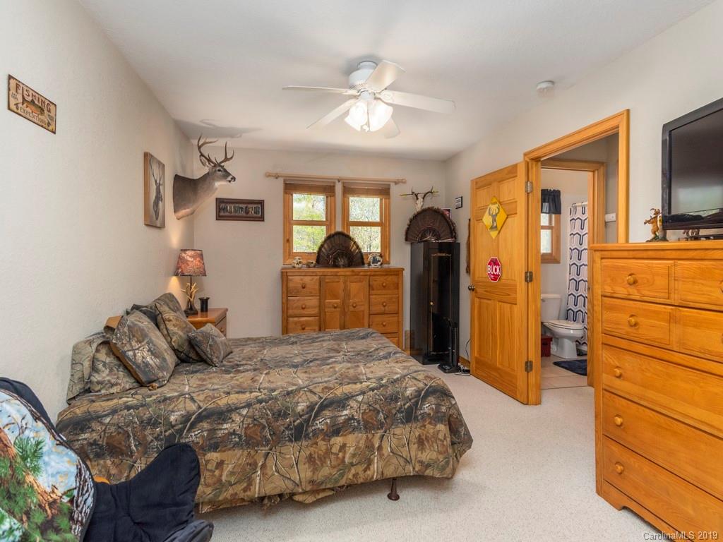 58 Thunder Ridge Road Canton, NC 28716 - Photo 16 of 26 a bedroom with a bed and wooden floor