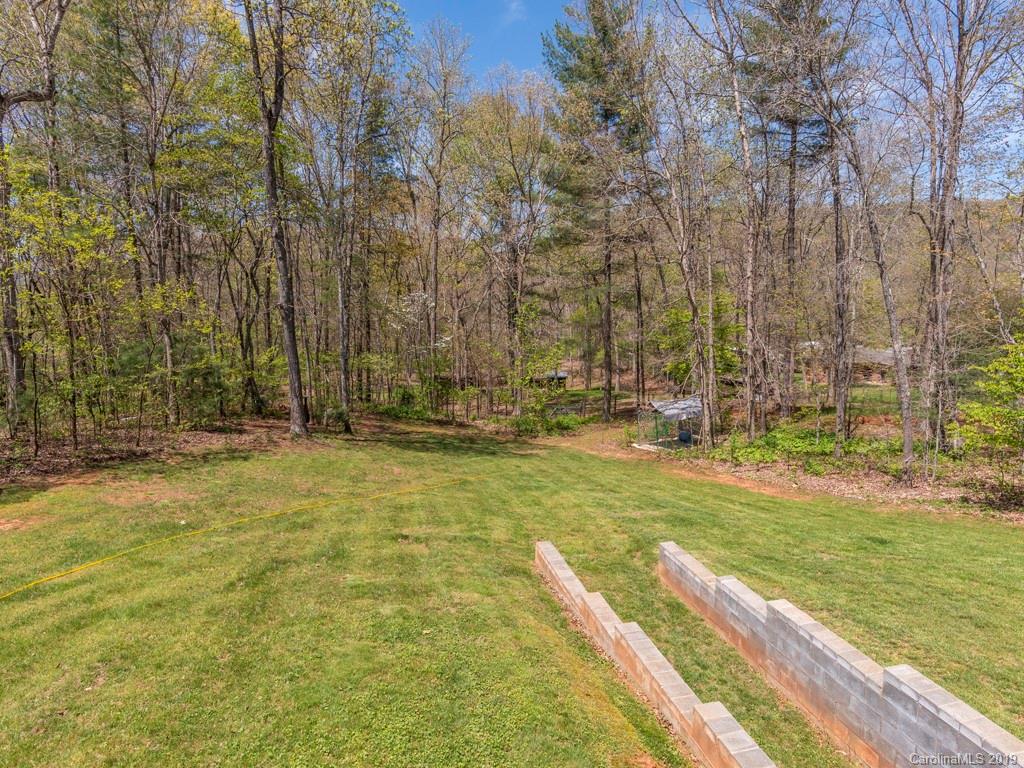 58 Thunder Ridge Road Canton, NC 28716 - Photo 19 of 26 a view of swimming pool with lawn chairs and large trees