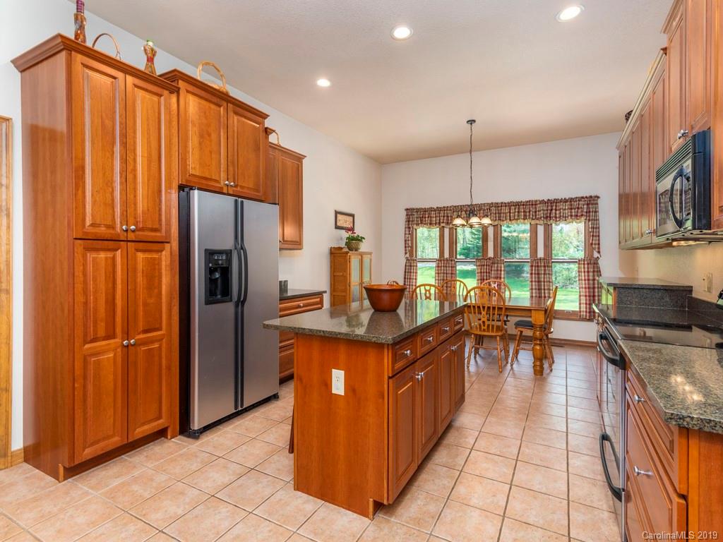 58 Thunder Ridge Road Canton, NC 28716 - Photo 4 of 26 a kitchen with stainless steel appliances granite countertop a refrigerator a sink and a stove