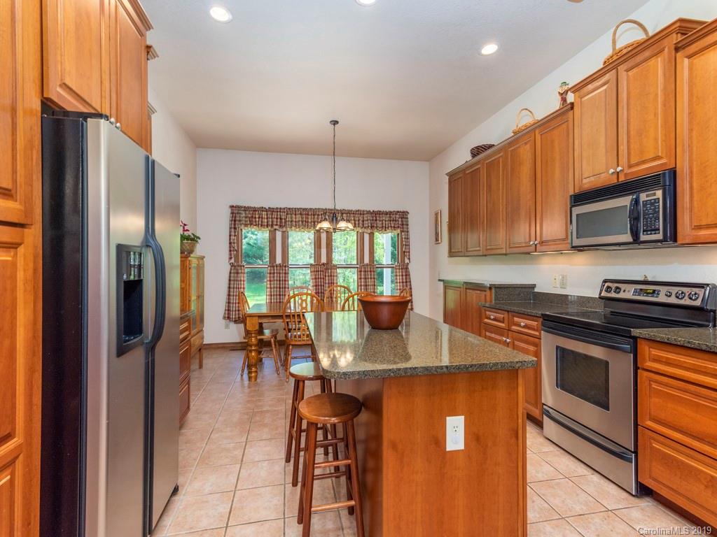 58 Thunder Ridge Road Canton, NC 28716 - Photo 5 of 26 a kitchen with stainless steel appliances granite countertop a refrigerator stove and sink