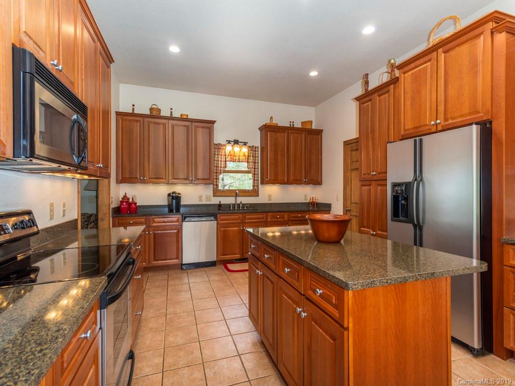 58 Thunder Ridge Road Canton, NC 28716 - Photo 7 of 26 a kitchen with stainless steel appliances granite countertop a stove a sink dishwasher a refrigerator and a microwave
