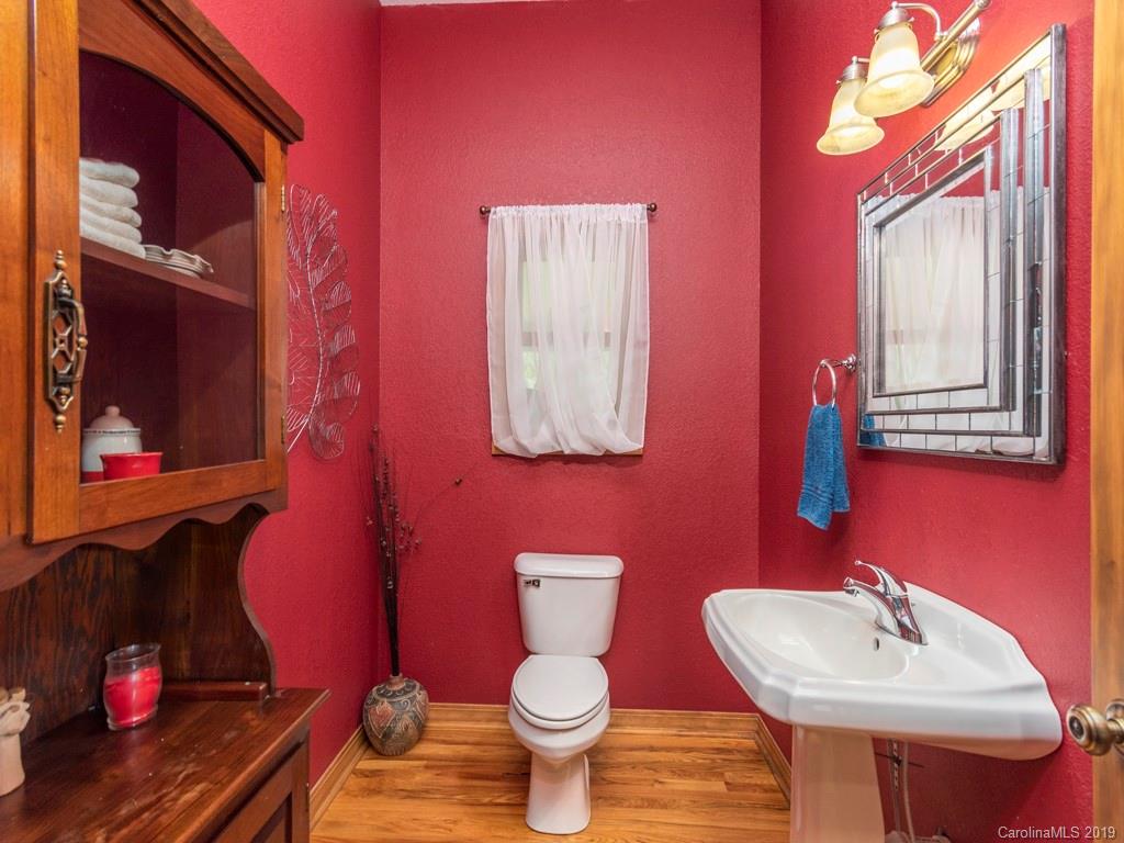 58 Thunder Ridge Road Canton, NC 28716 - Photo 8 of 26 a bathroom with a toilet sink and mirror