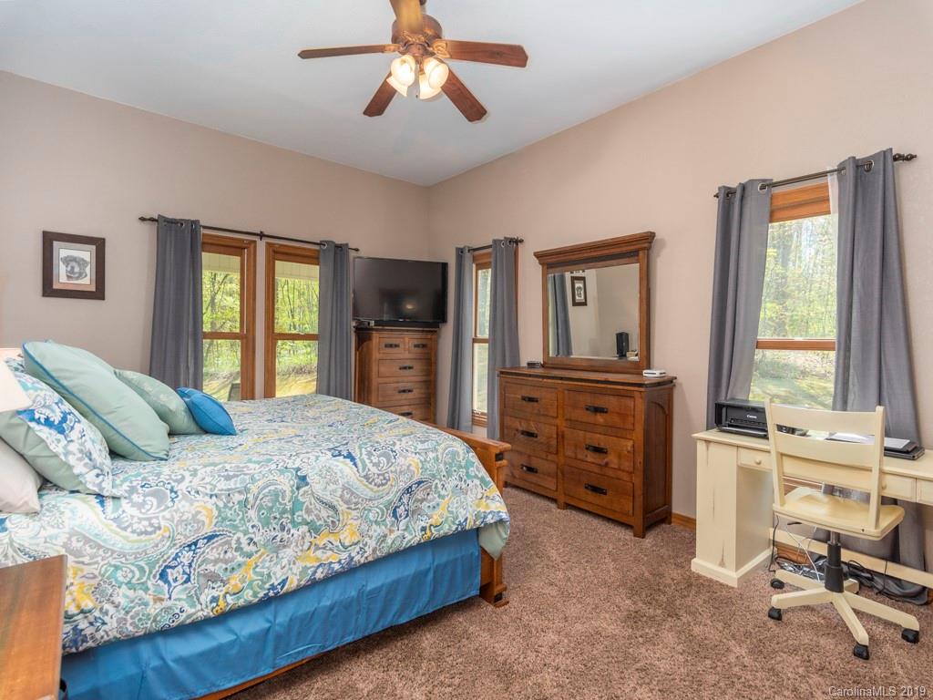 58 Thunder Ridge Road Canton, NC 28716 - Photo 9 of 26 a bedroom with a bed and a dresser