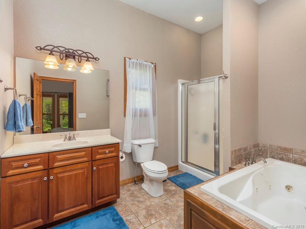 58 Thunder Ridge Road Canton, NC 28716 - Photo 10 of 26 a bathroom with a sink a toilet and shower
