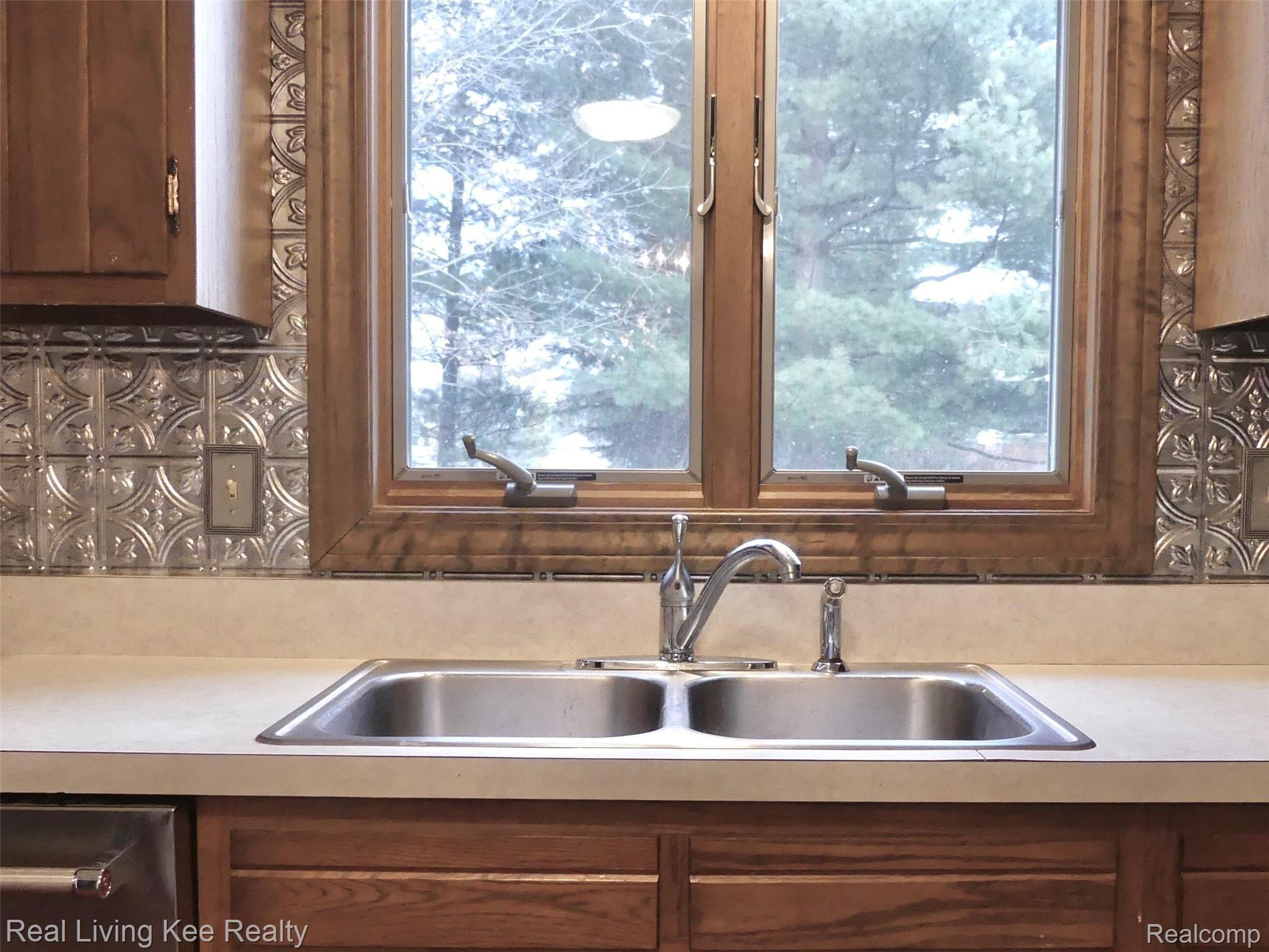 137 Aintree Road Rochester, MI 48306 - Photo 11 of 48 View of treed backyard from kitchen sink