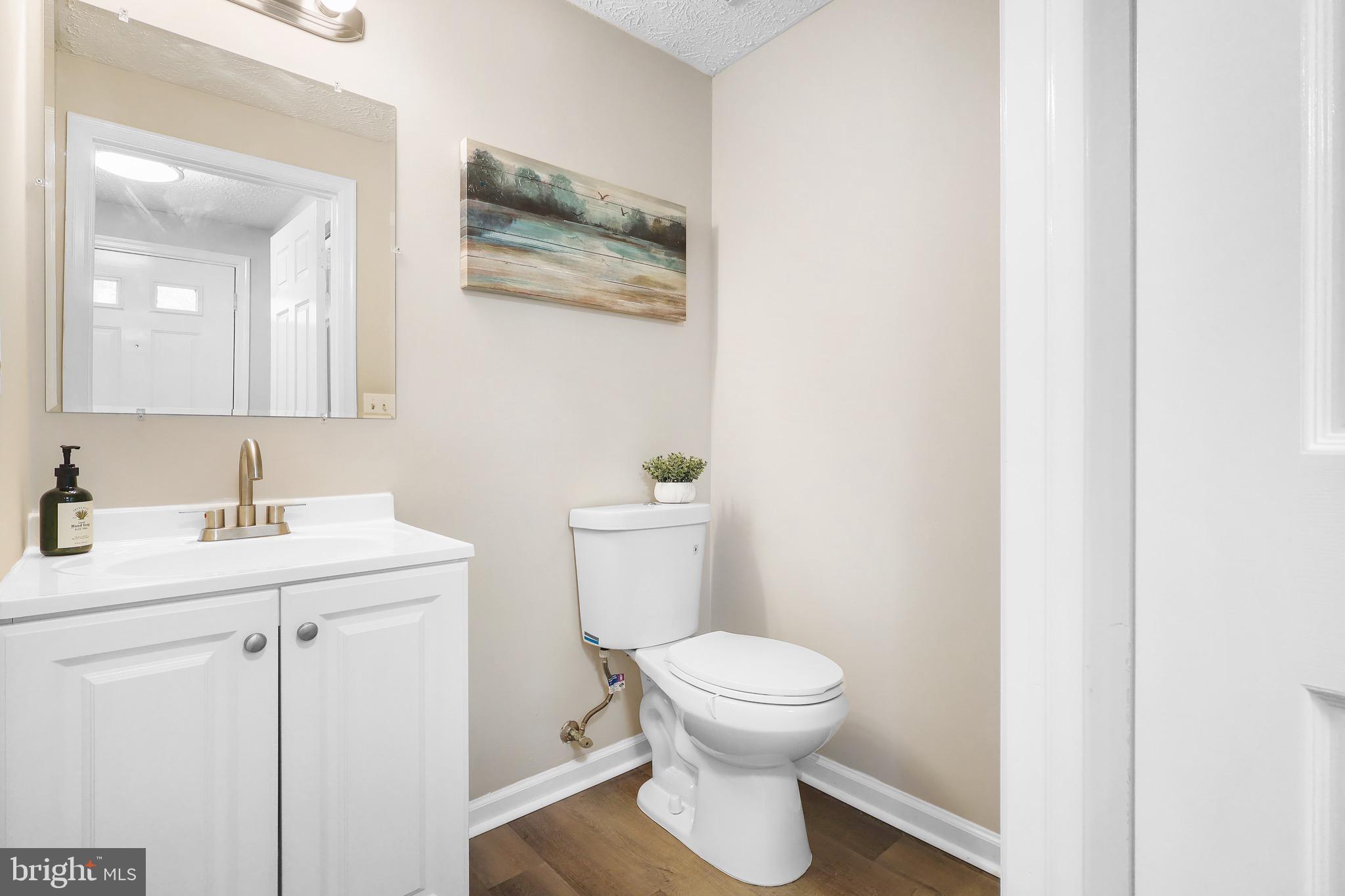 1108 Casper Drive Herndon, VA 20170 - Photo 11 of 24 a bathroom with a toilet a sink and mirror