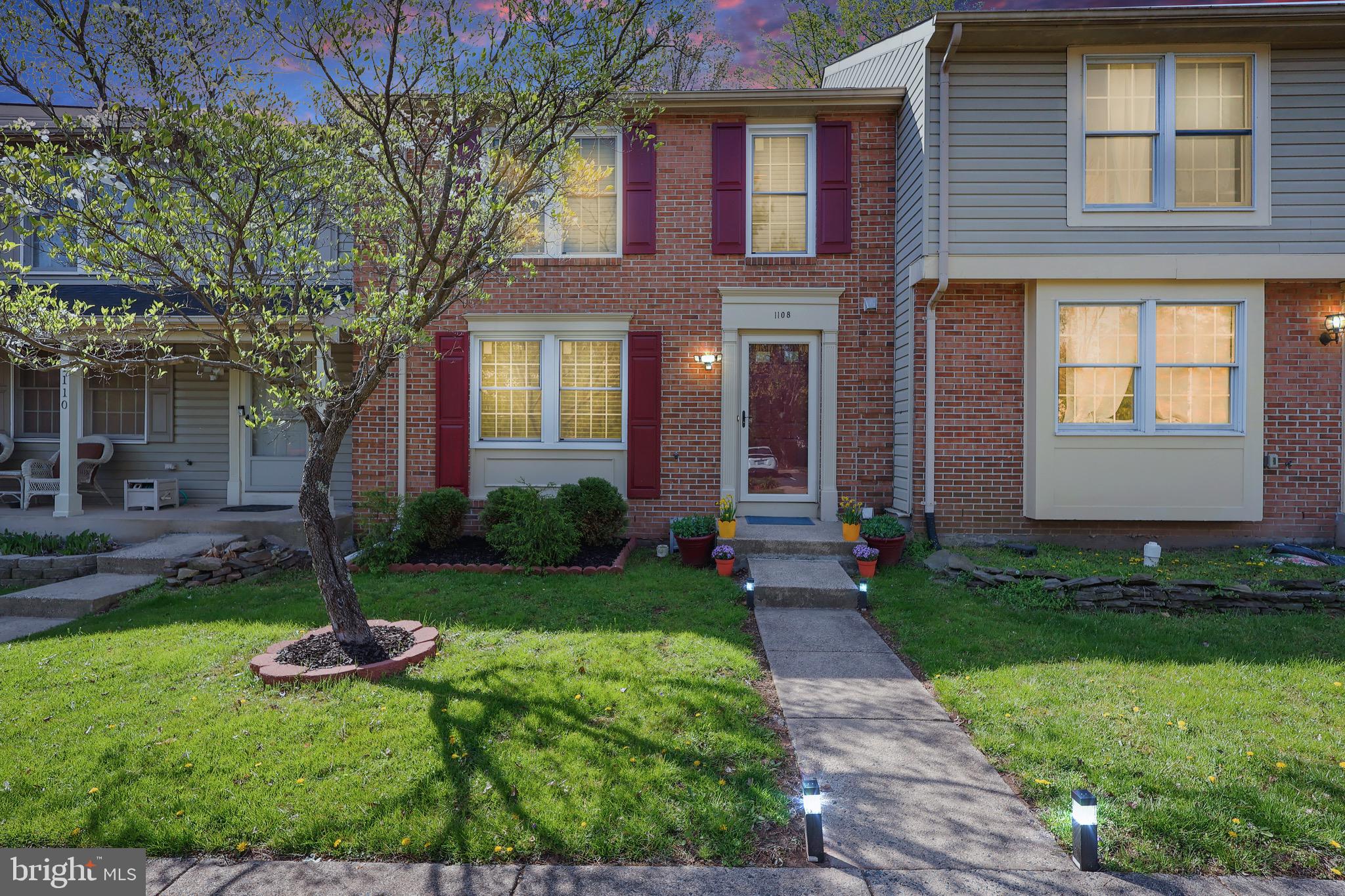 1108 Casper Drive Herndon, VA 20170 - Photo 2 of 24 a front view of a house with garden and trees