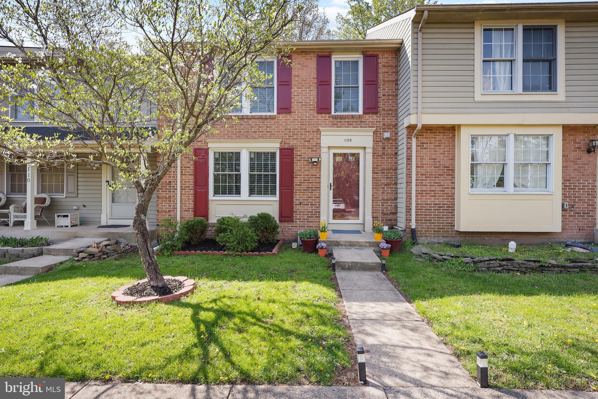 1108 Casper Drive Herndon, VA 20170 - Photo 3 of 24 a front view of a house with garden and trees