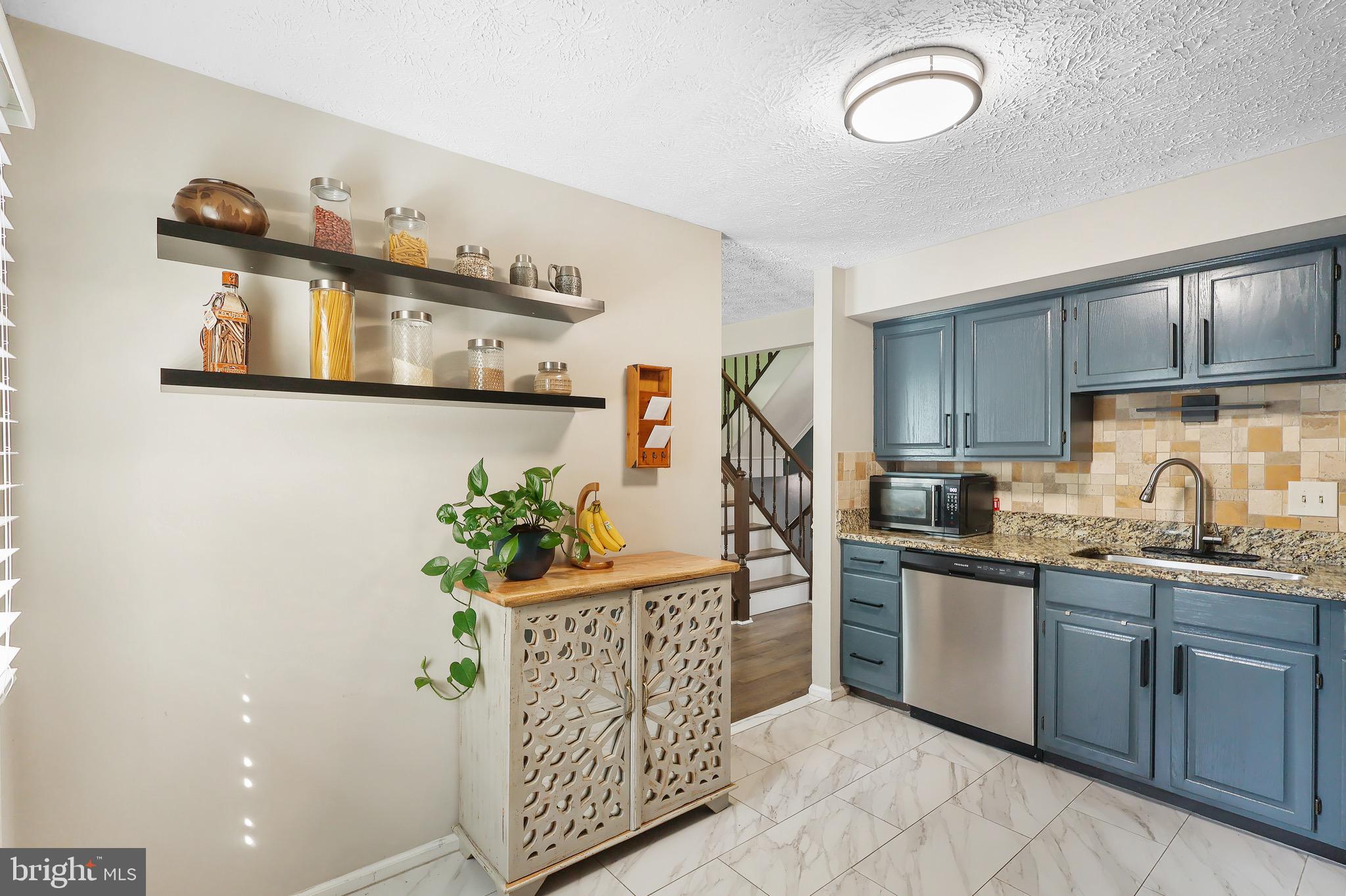 1108 Casper Drive Herndon, VA 20170 - Photo 9 of 24 a kitchen with stainless steel appliances granite countertop a sink a stove a refrigerator and cabinets