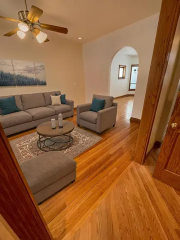 a living room with furniture and a wooden floor