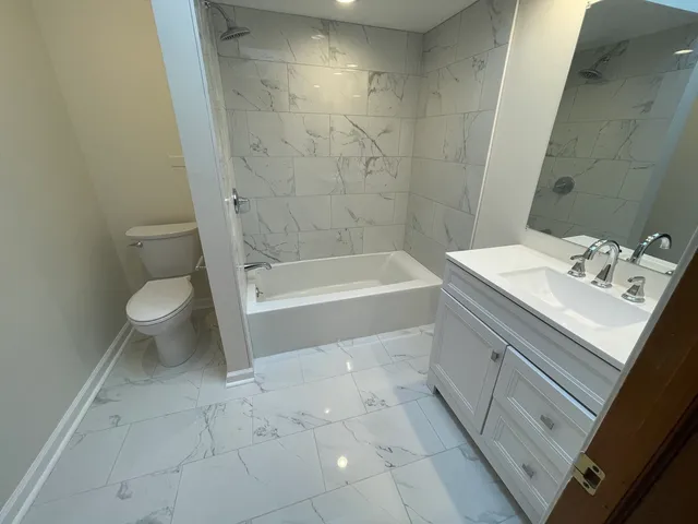 a bathroom with a sink a toilet and a bathtub