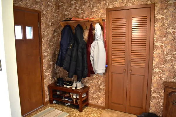 a view of walk in closet with clothes