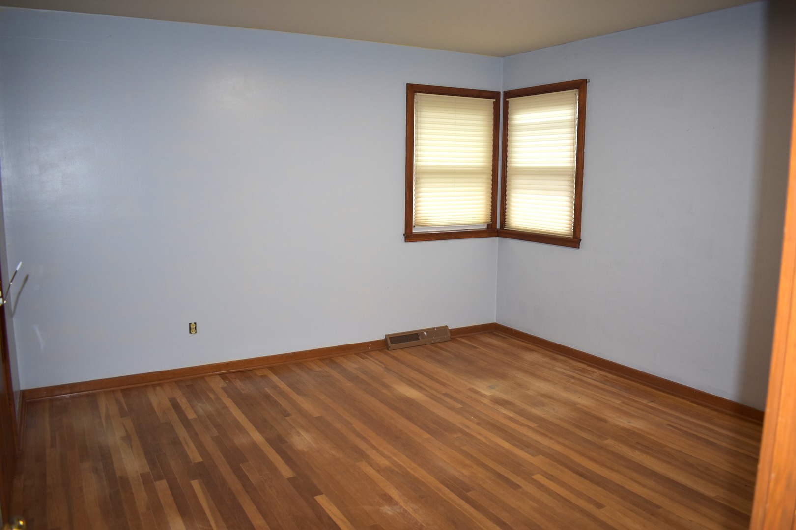 1500 Manhattan Drive Streator, IL 61364 - Photo 7 of 24 a view of an empty room with wooden floor and a window