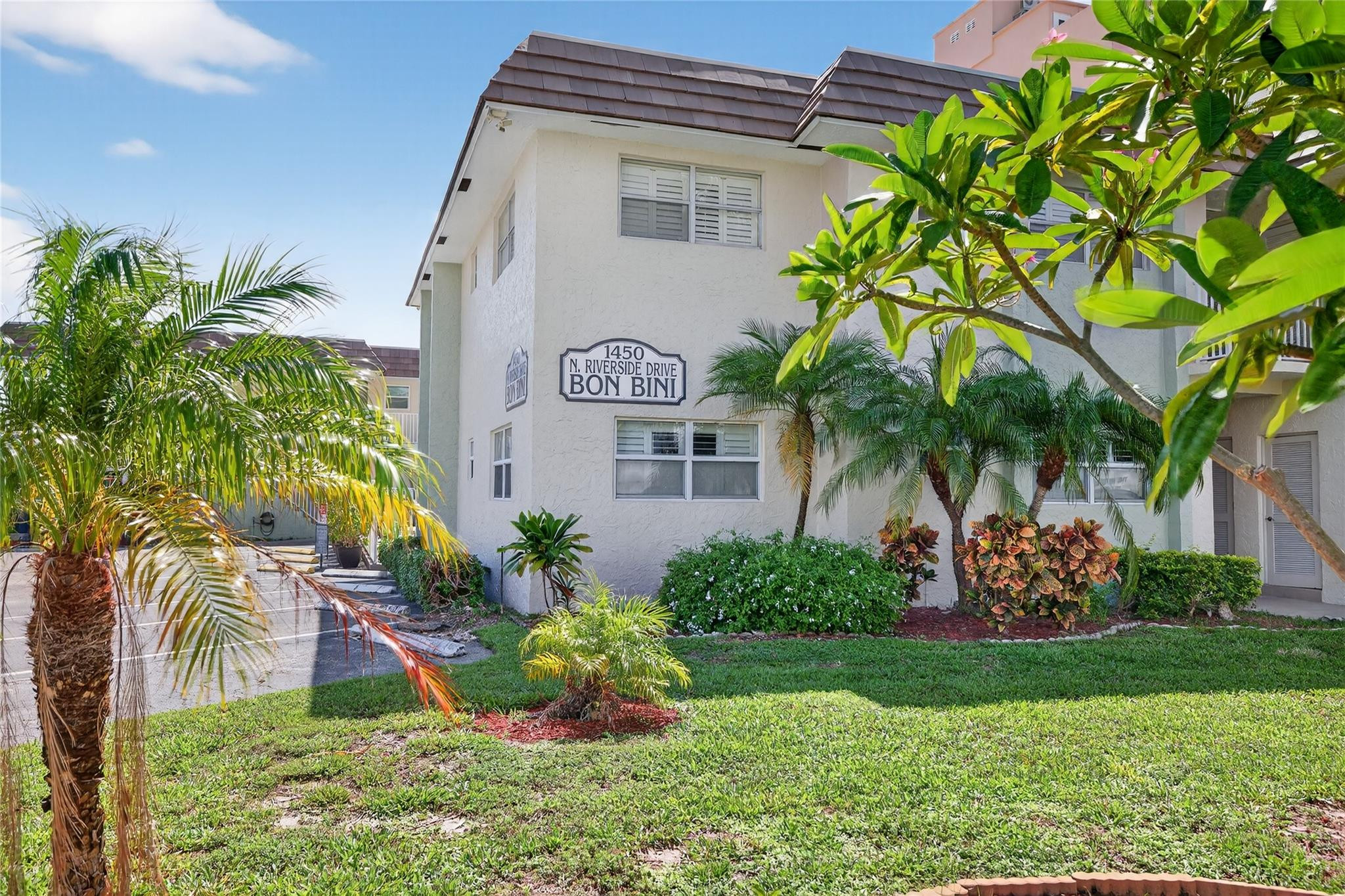 1450 North Riverside Drive, Unit 102 Pompano Beach, FL 33062 - Photo 19 of 32 a front view of a house with garden