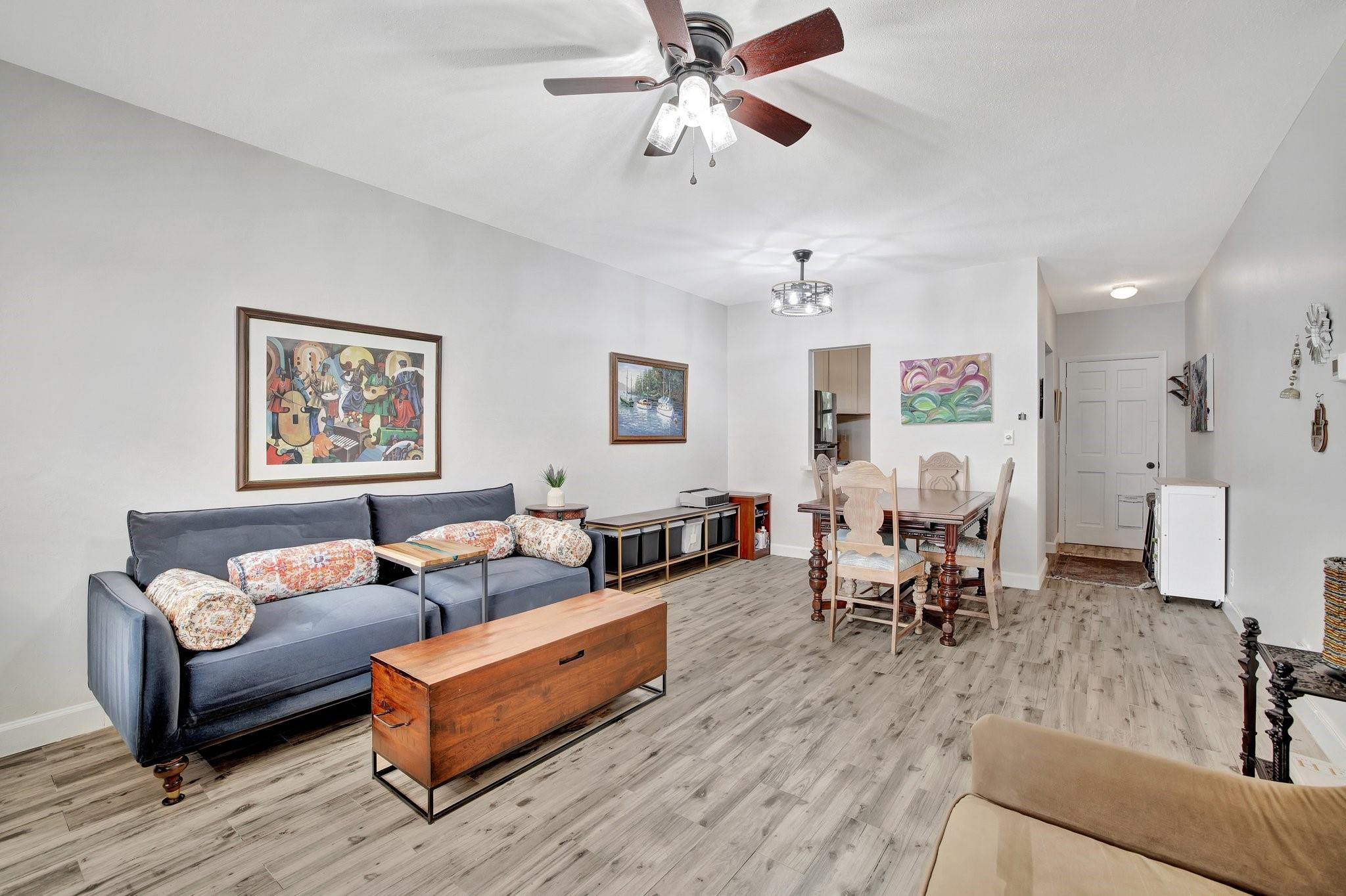 1450 North Riverside Drive, Unit 102 Pompano Beach, FL 33062 - Photo 2 of 32 a living room with furniture and a chandelier