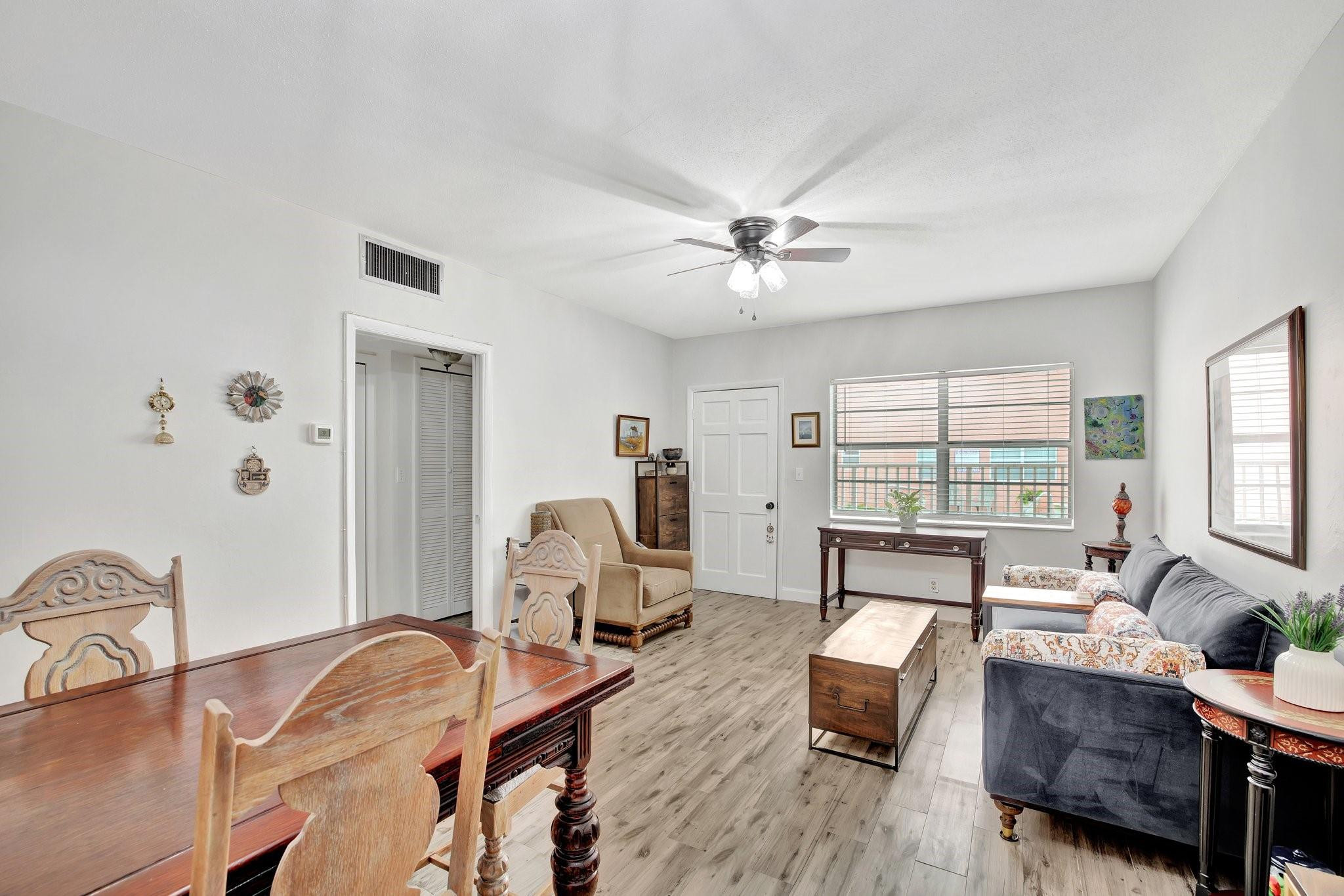 1450 North Riverside Drive, Unit 102 Pompano Beach, FL 33062 - Photo 5 of 32 a living room with furniture and wooden floor