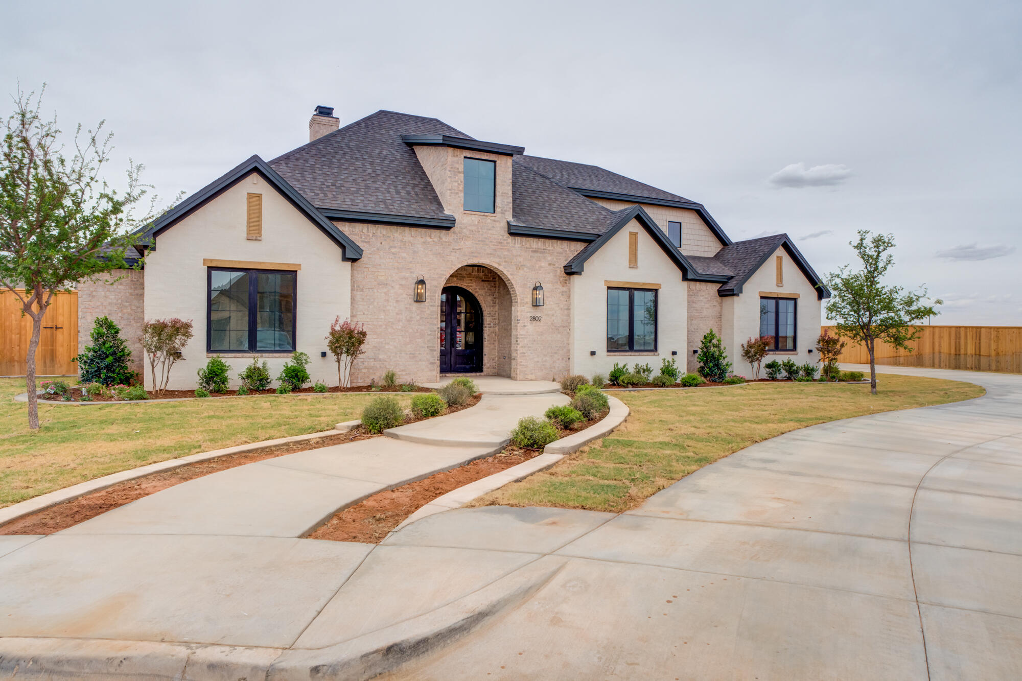 2802 151st Street Lubbock, TX 79423 - Photo 2 of 60 a front view of a house with a yard and garage