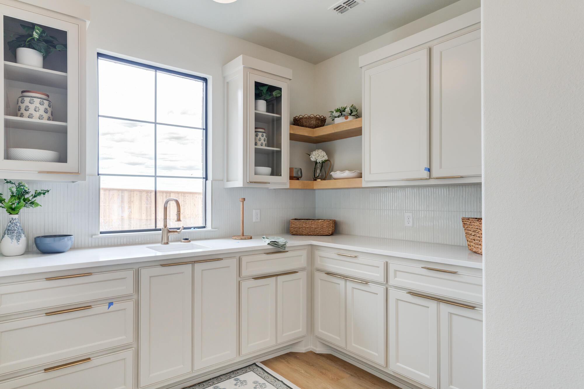2802 151st Street Lubbock, TX 79423 - Photo 27 of 60 a kitchen with white cabinets and window