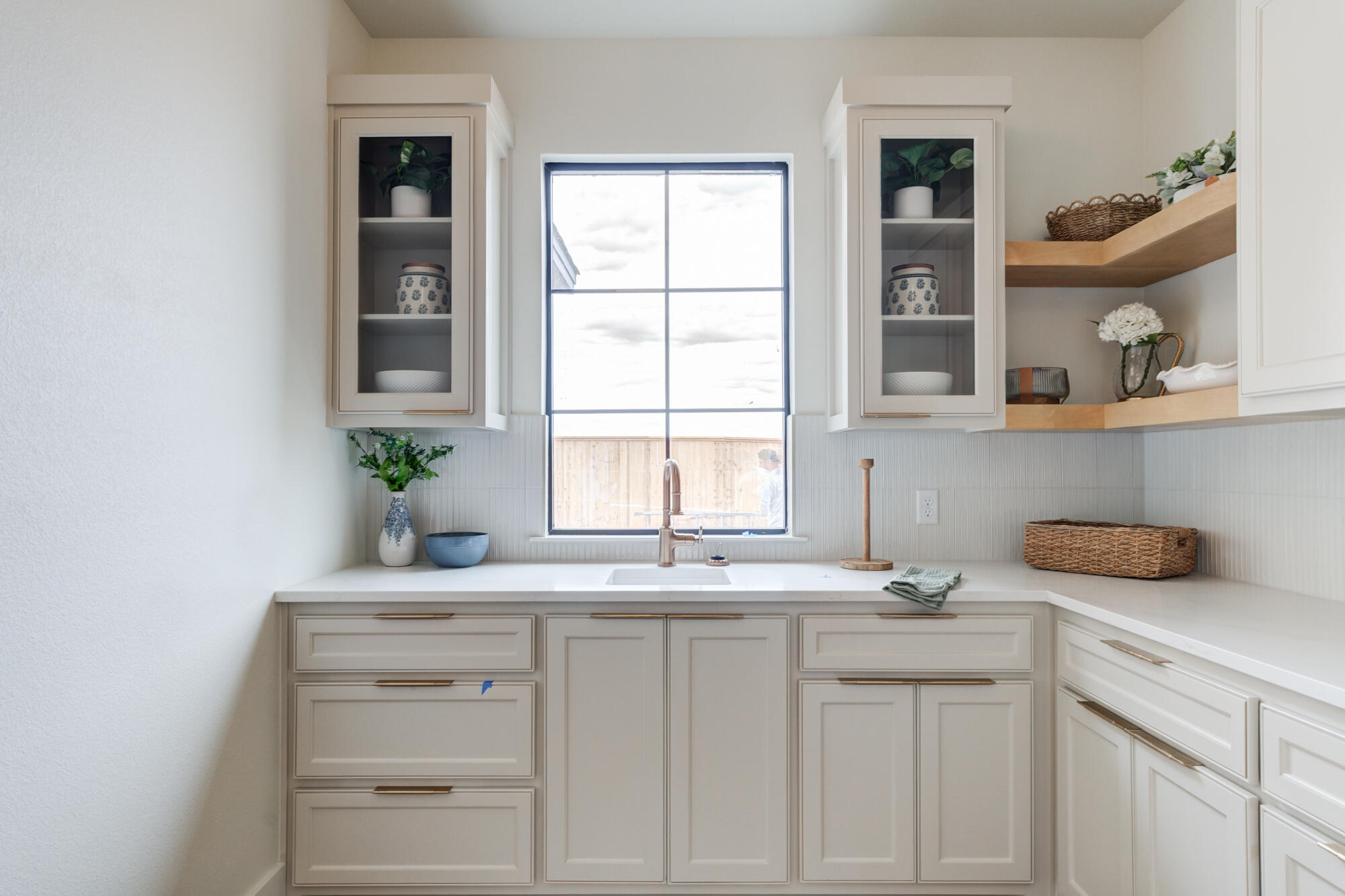 2802 151st Street Lubbock, TX 79423 - Photo 28 of 60 a kitchen with white cabinets and a window