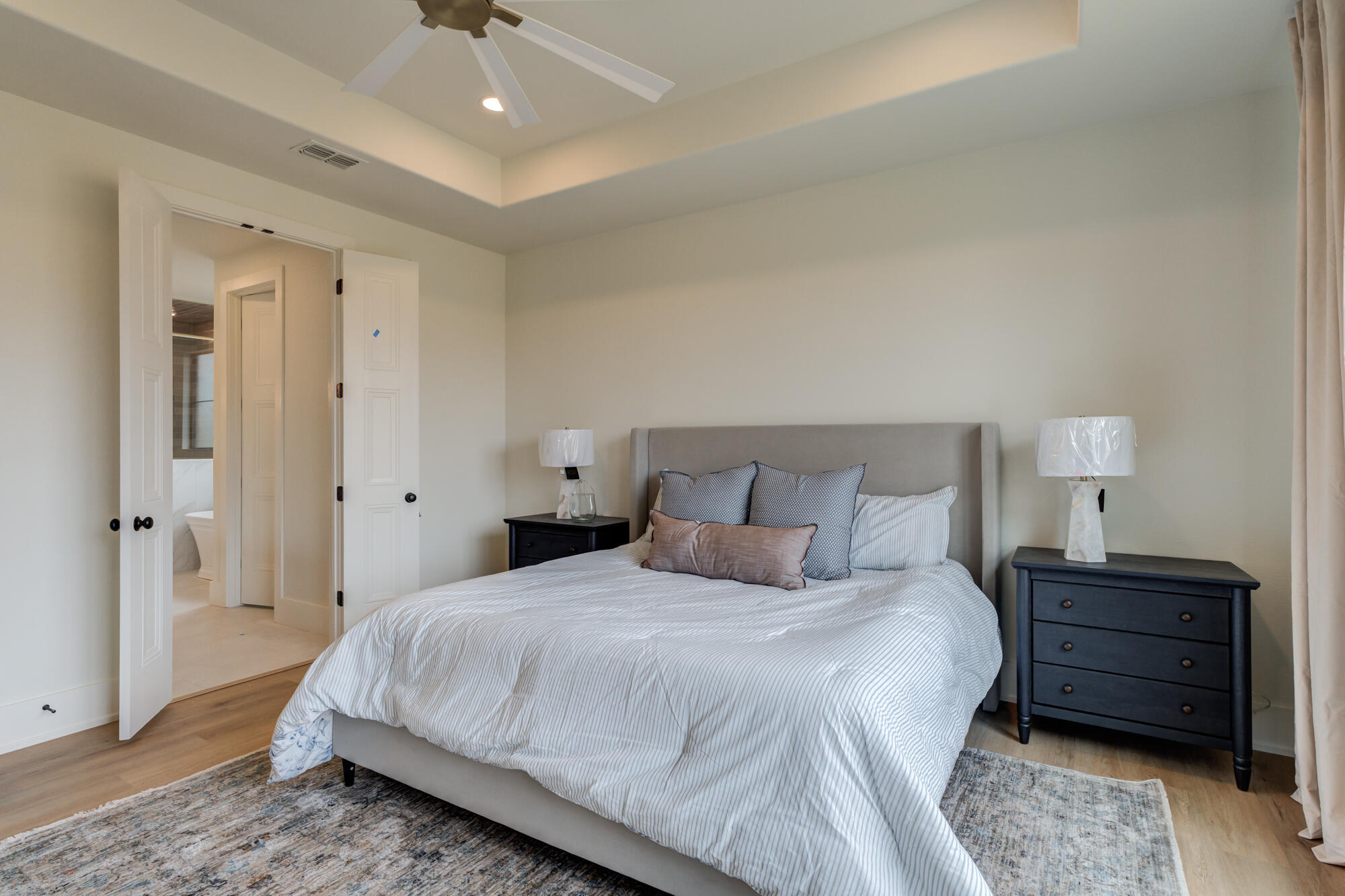 2802 151st Street Lubbock, TX 79423 - Photo 30 of 60 a bedroom with a bed a lamp and a rug