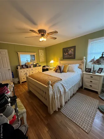 a bedroom with bed and a chandelier