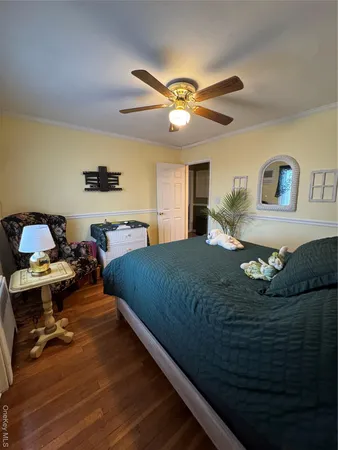 a bedroom with a bed gym equipment and view of living room