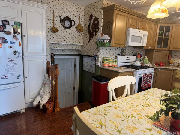 a bed sitting in a kitchen next to a window