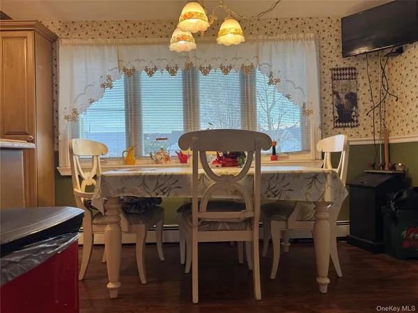 a dining room with furniture and wooden floor