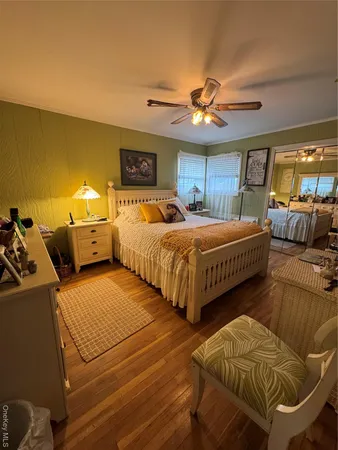 a bedroom with double bed and a chandelier