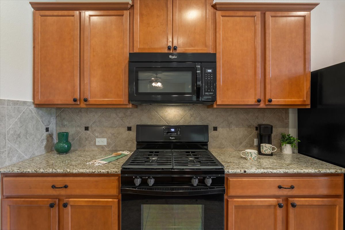 108 Cathedral Mountain Pass Georgetown, TX 78633 - Photo 13 of 36 a stove top oven sitting inside of a kitchen