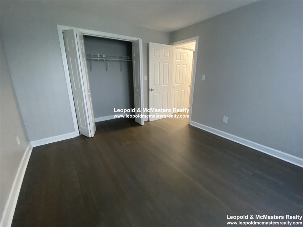 519 Washington Street, Unit 2 Brookline, MA 02446 - Photo 10 of 11 an empty room with wooden floor and windows