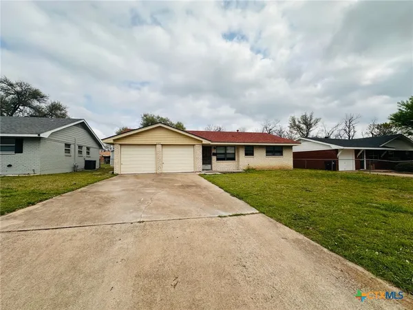 a front view of house with yard and green space