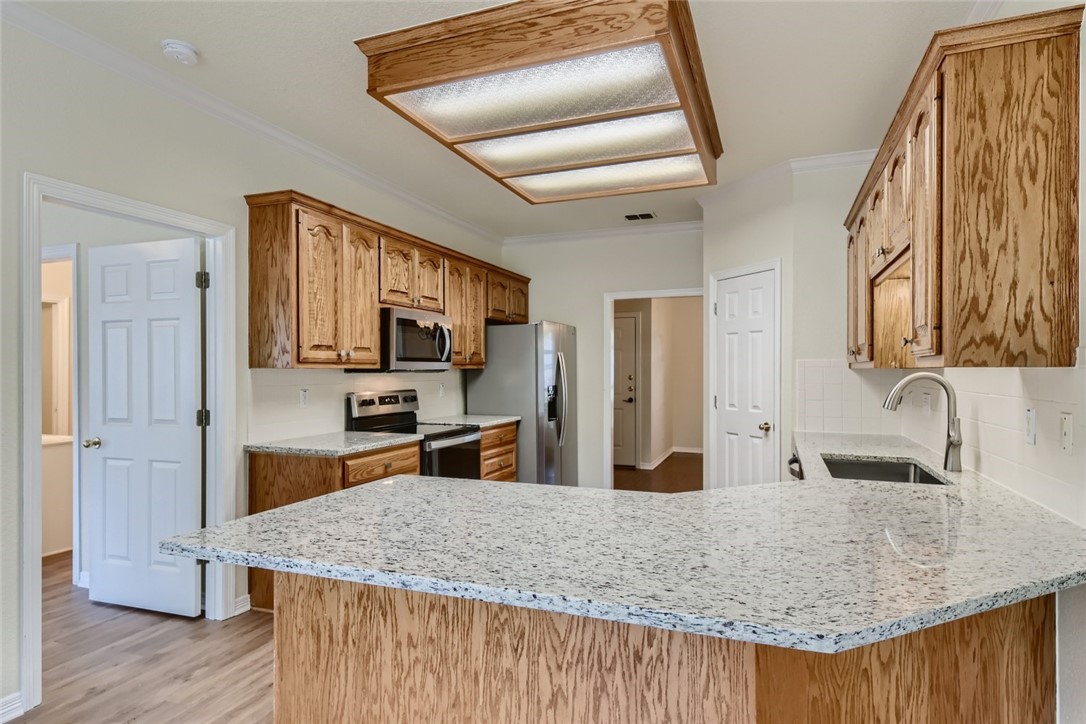 511 Susana Drive Georgetown, TX 78628 - Photo 14 of 31 Kitchen with granite counter tops and stainless steel appliances