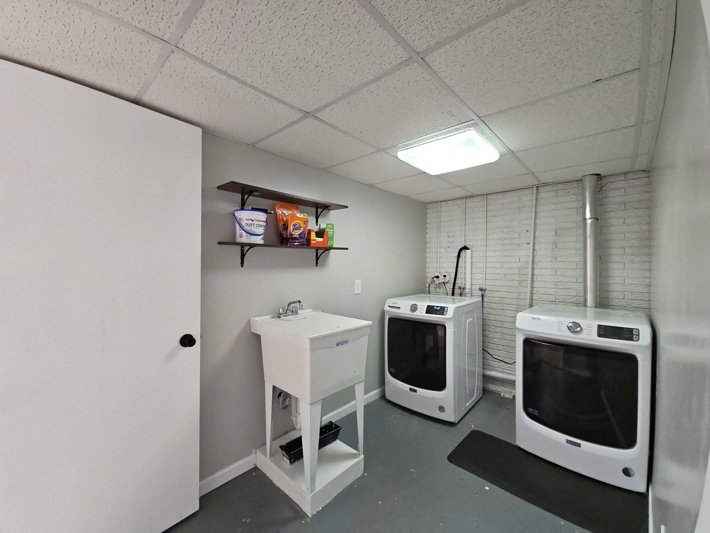 1322 Calvin Street Davenport, IA 52804 - Photo 21 of 25 a utility room with dryer washer and a view of living room