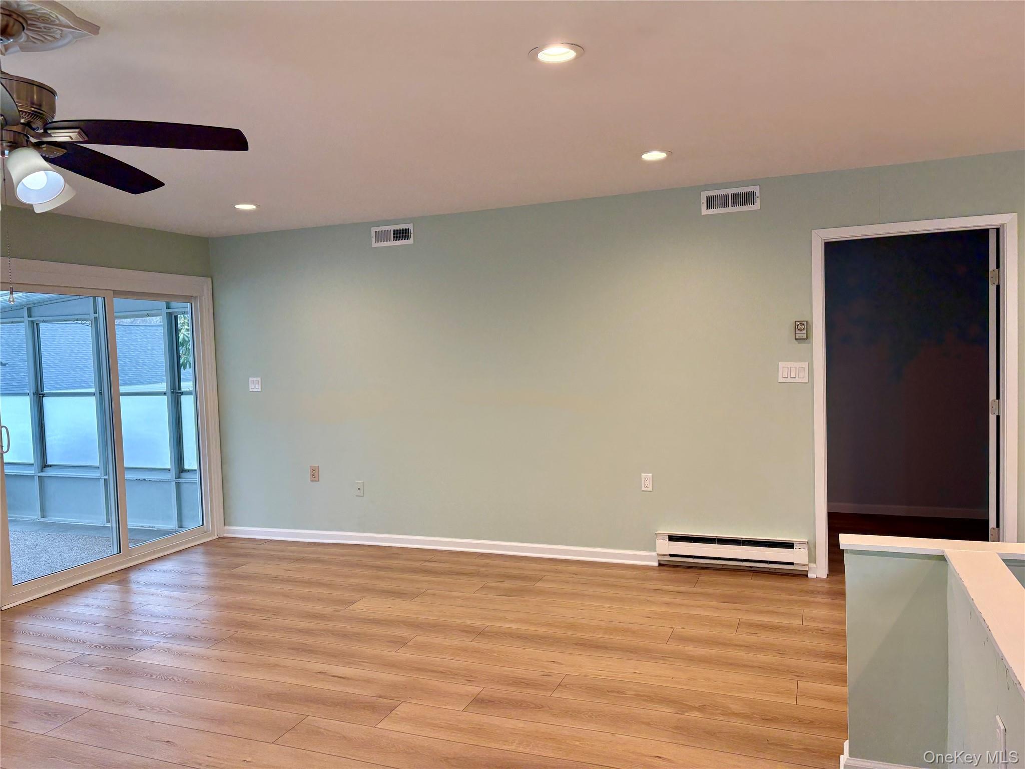 498 Cranston Lane Ridge, NY 11961 - Photo 10 of 30 Living area opens to three seasons room