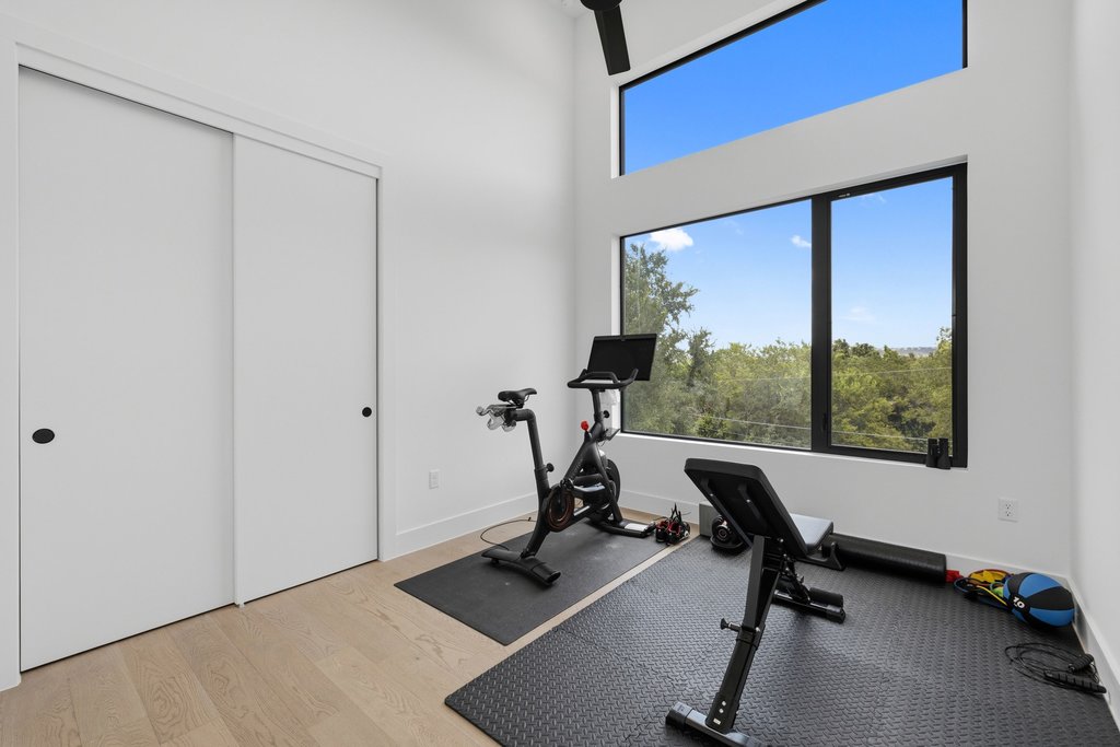 1712 Saracen Road Austin, TX 78733 - Photo 17 of 20 a view of a workspace with gym equipment