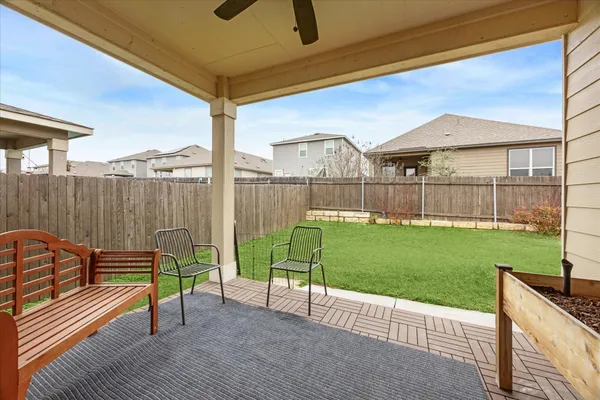 a view of a chairs and table in the backyard