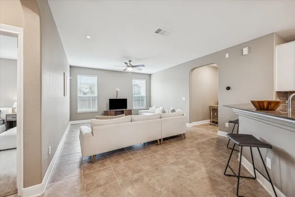 a large white room with a large window and furniture