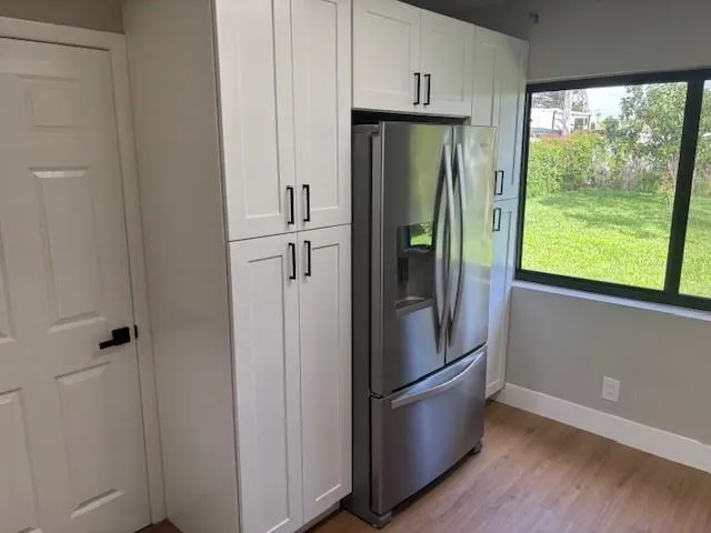 a kitchen with stainless steel appliances a refrigerator and a window