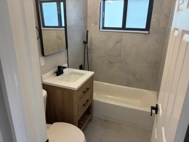 a bathroom with a sink toilet and tub