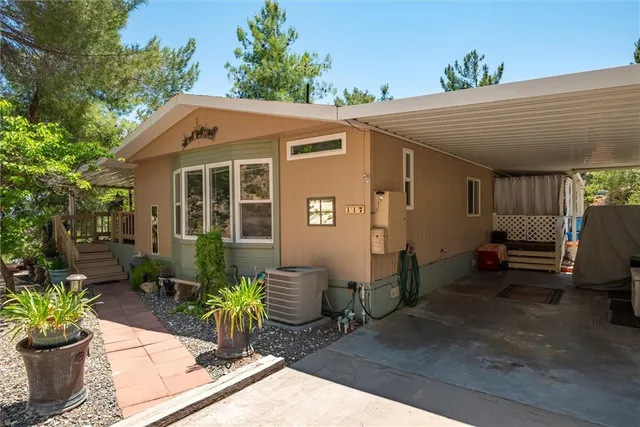 a view of a patio with table and chairs under an umbrella