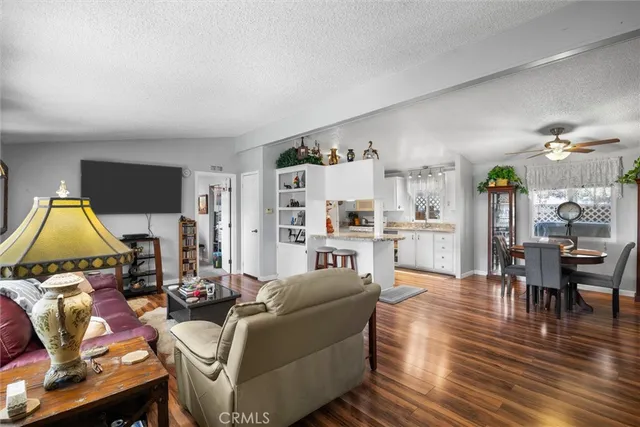 a living room with furniture wooden floor and a flat screen tv