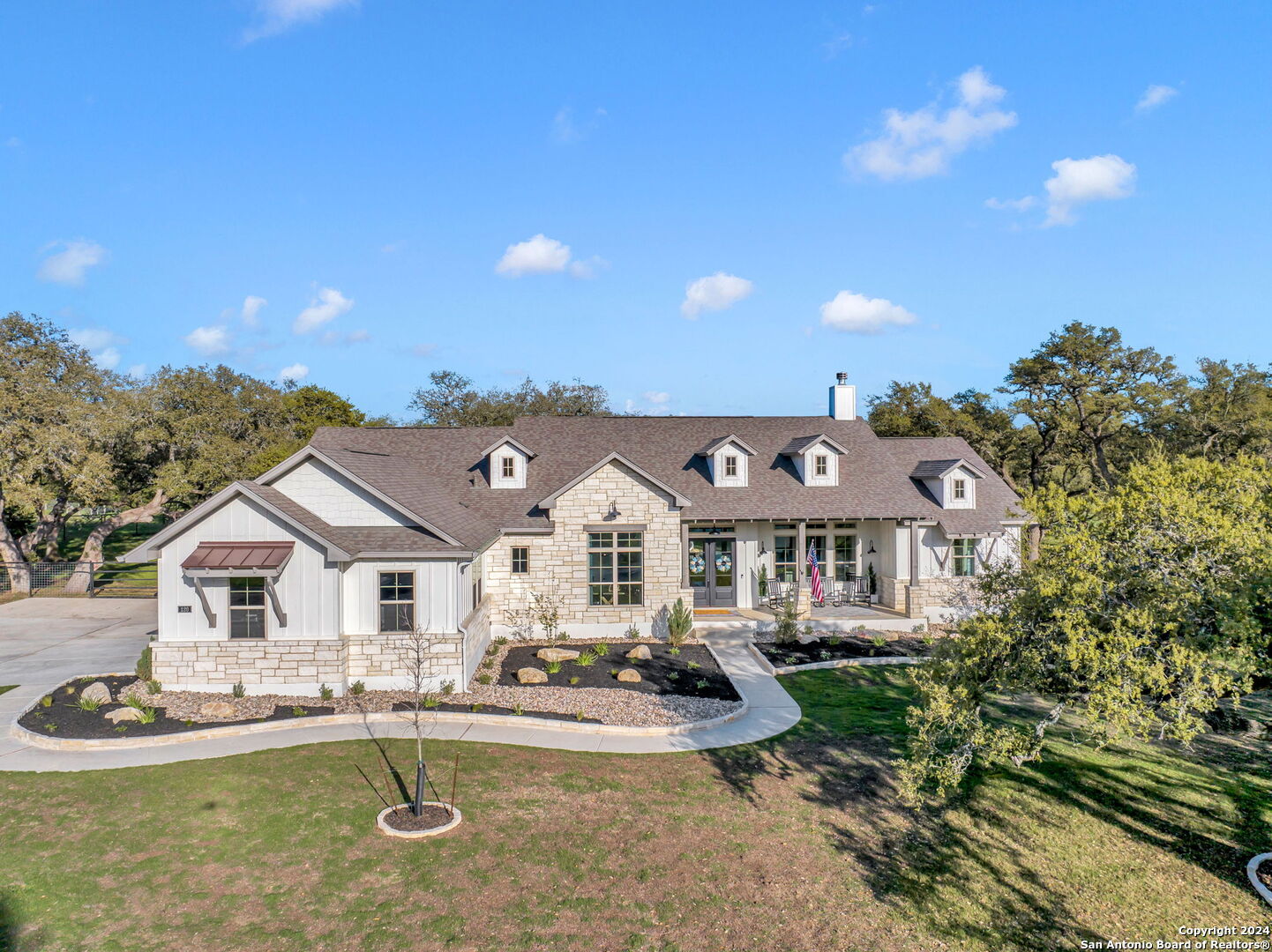 a front view of a house with a yard garage and outdoor seating