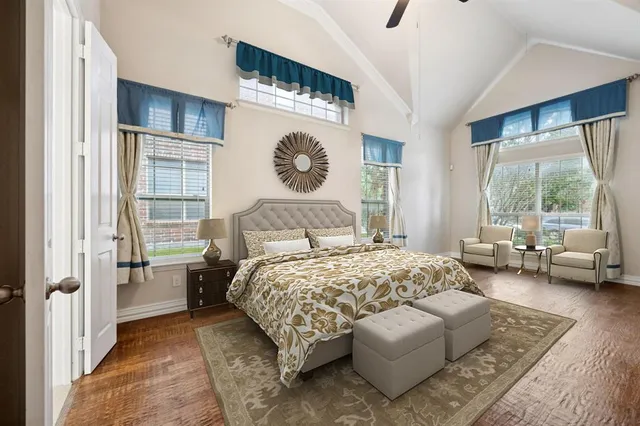 a bedroom with a bed couch and a window with outer view