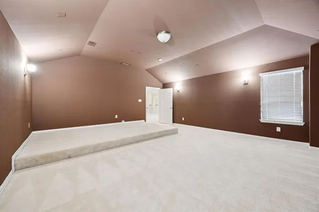 a bedroom with a bed and a night stand